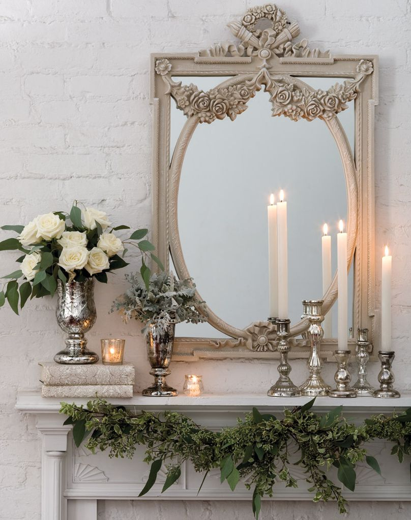 Modern fireplace combined with white flowers and wintage mirror above it