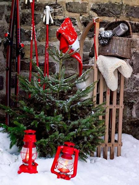 Paint-them-bright-red-and-placed-them-on-the-yard-along-with-a-red-santa-cap-and-a-sled.