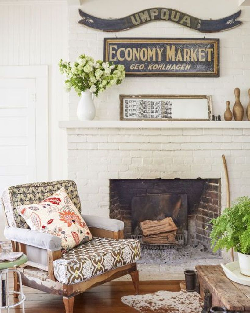 Patterned chair beside fireplace combined with wooden table to make an elegant your farmhouse living room