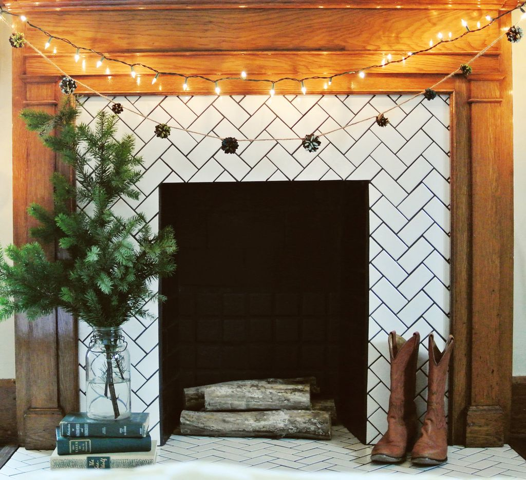 Perfect fireplace combined with pine cone garland and string lamps
