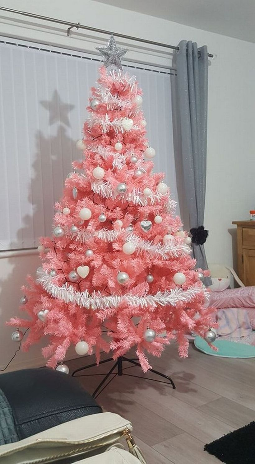 Pink chrismast tree combine with white ornament and white ribbon