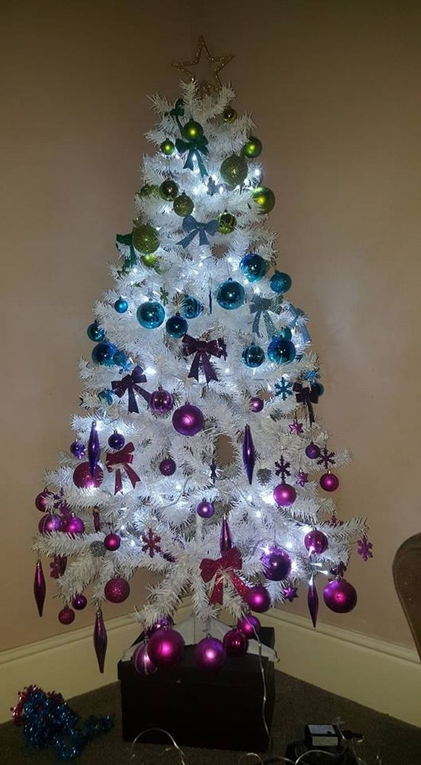 Small chrismast tree with colorful ornament and white light