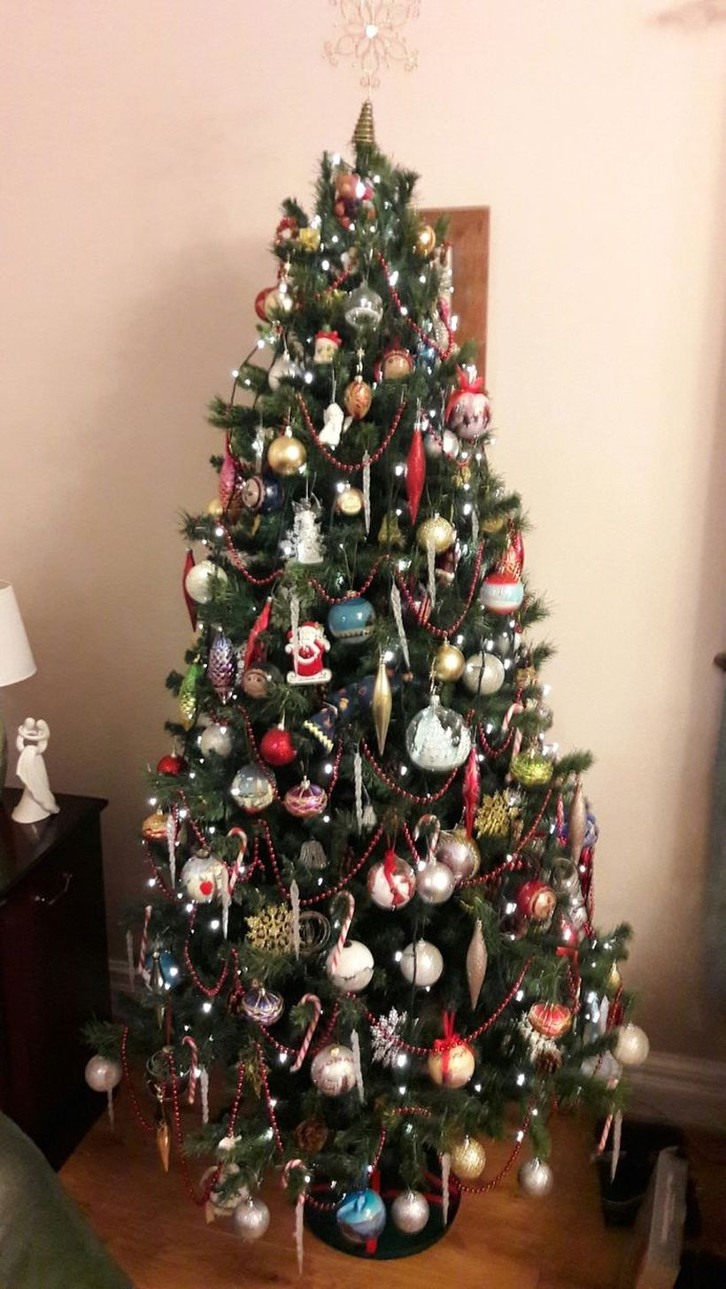 Small green chrismast with colorful ornament
