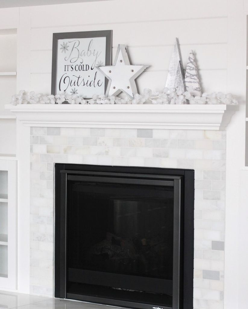 White fireplace combined with winter ornament