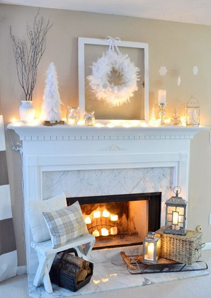 White fireplace with wreath above it