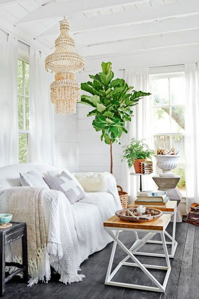 White sofa and iron coffee table combined with plants decoration to make more natural your living room