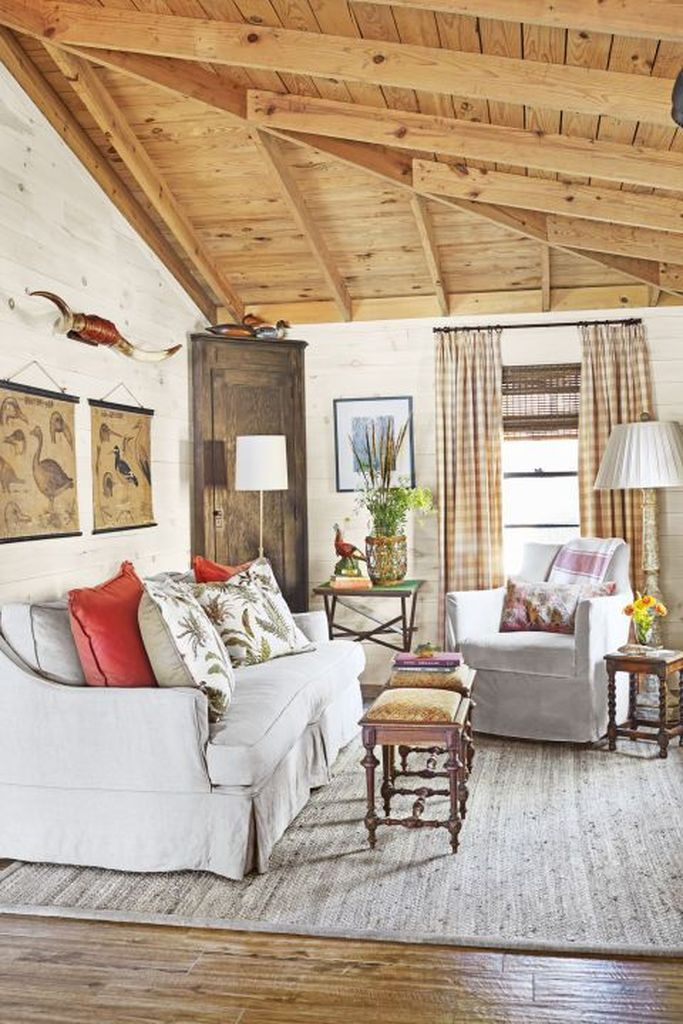 White sofa, small coffee tables combined with wooden closet at the corner to make more your an amazing farmhouse living room
