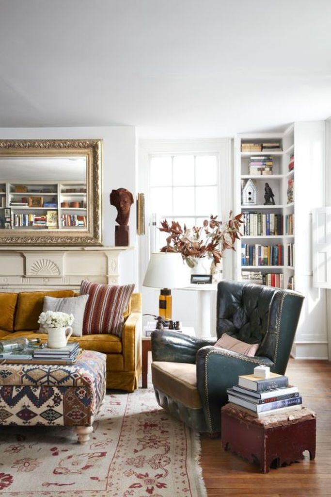 Yellow sofa and patterned table combined with dark chairs to make a classy your farmhouse living room