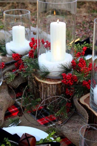 A-centerpiece-of-fresh-sprigs-of-greenery-and-candles-in-glass-vases.
