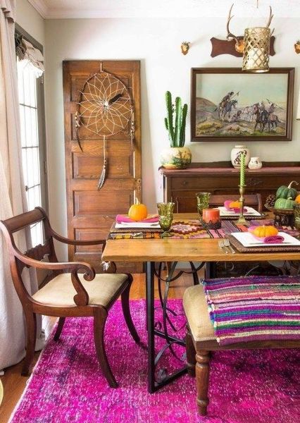 A-super-colorful-boho-dining-room-with-a-dream-catcher-elegant-wooden-furniture-potted-cacti-and-colorful-textiles