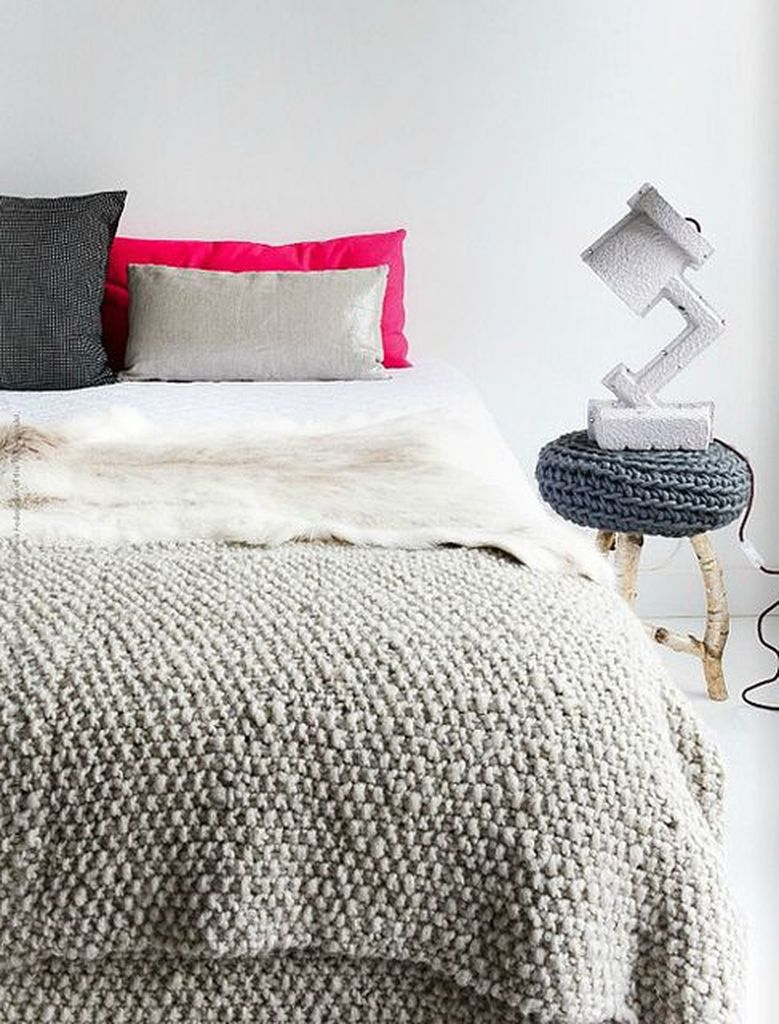 Bedroom with knit blankets and pillows