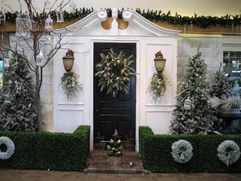 White-and-gold-baubles-and-pine-cones-on-the-front-door-contains-pine-leaves.