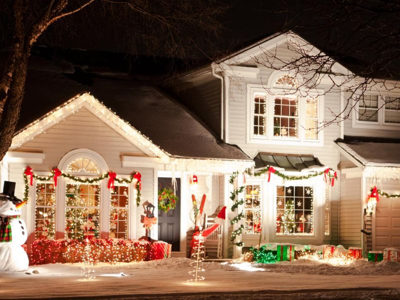 With-vibrant-lighting-garland-red-bows-wreaths-and-candles-in-the-windows.