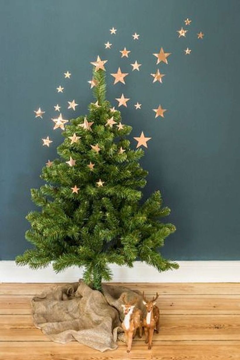 11-a-small-christmas-tree-with-burlap-on-the-floor-and-copper-foli-stars-as-decor-going-up-to-the-wall
