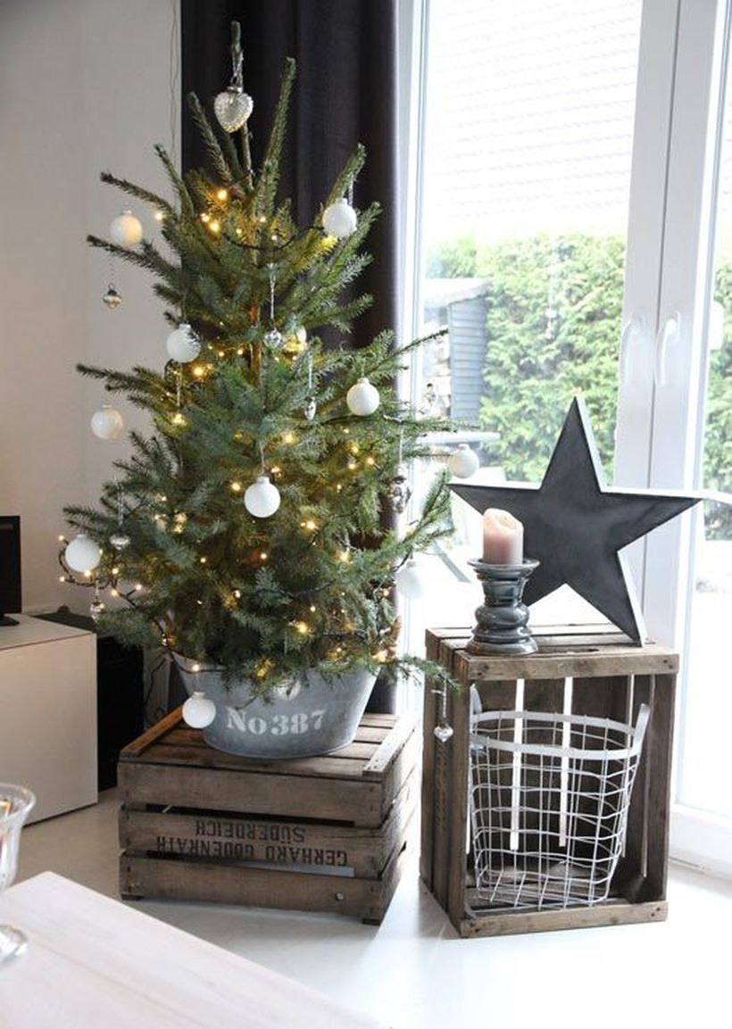 17-a-small-tree-in-a-galvanized-bucket-with-lights-and-white-ornaments-is-a-great-rustic-idea-for-christmas