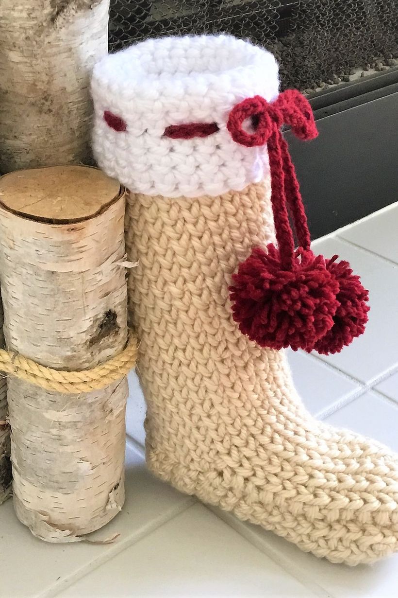 Classic-christmas-décor-ideas-with-reindeer-crochet-christmas-stocking-pattern.-this-crochet-stocking-will-fit-in-flawlessly.-the-pom-pom-bow-makes-it-look-even-more-comfy-and-cozy.