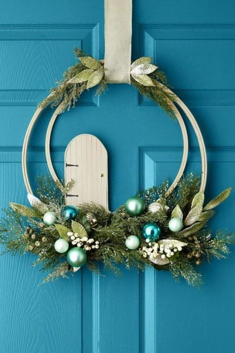 Welcoming-christmas-front-door-with-wreath-blue-is-a-beautiful-unexpected-color-choice-for-a-christmas-wreath.
