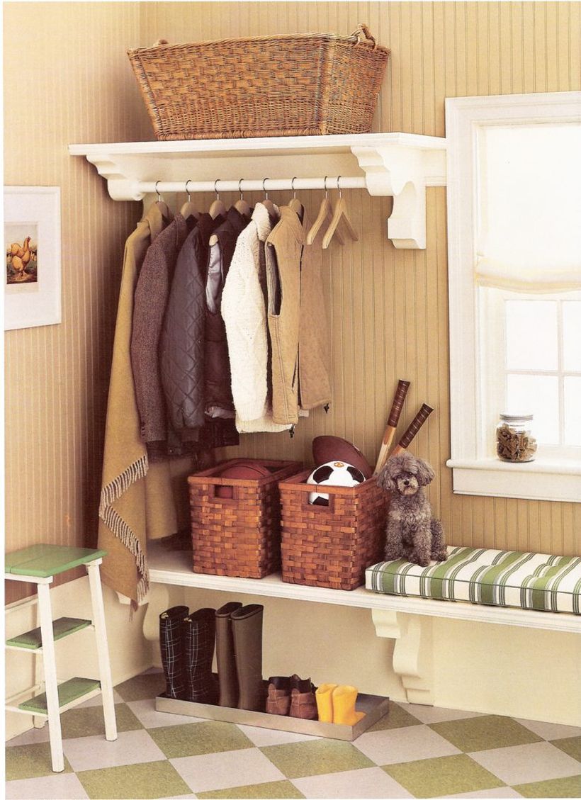 Mounted-wooden-bench-seat-with-cushion-above-shoe-and-boots-tray-storage-plus-rattan-basket-storage-under-clothing-hooks-in-the-corner-ideas-783x1078