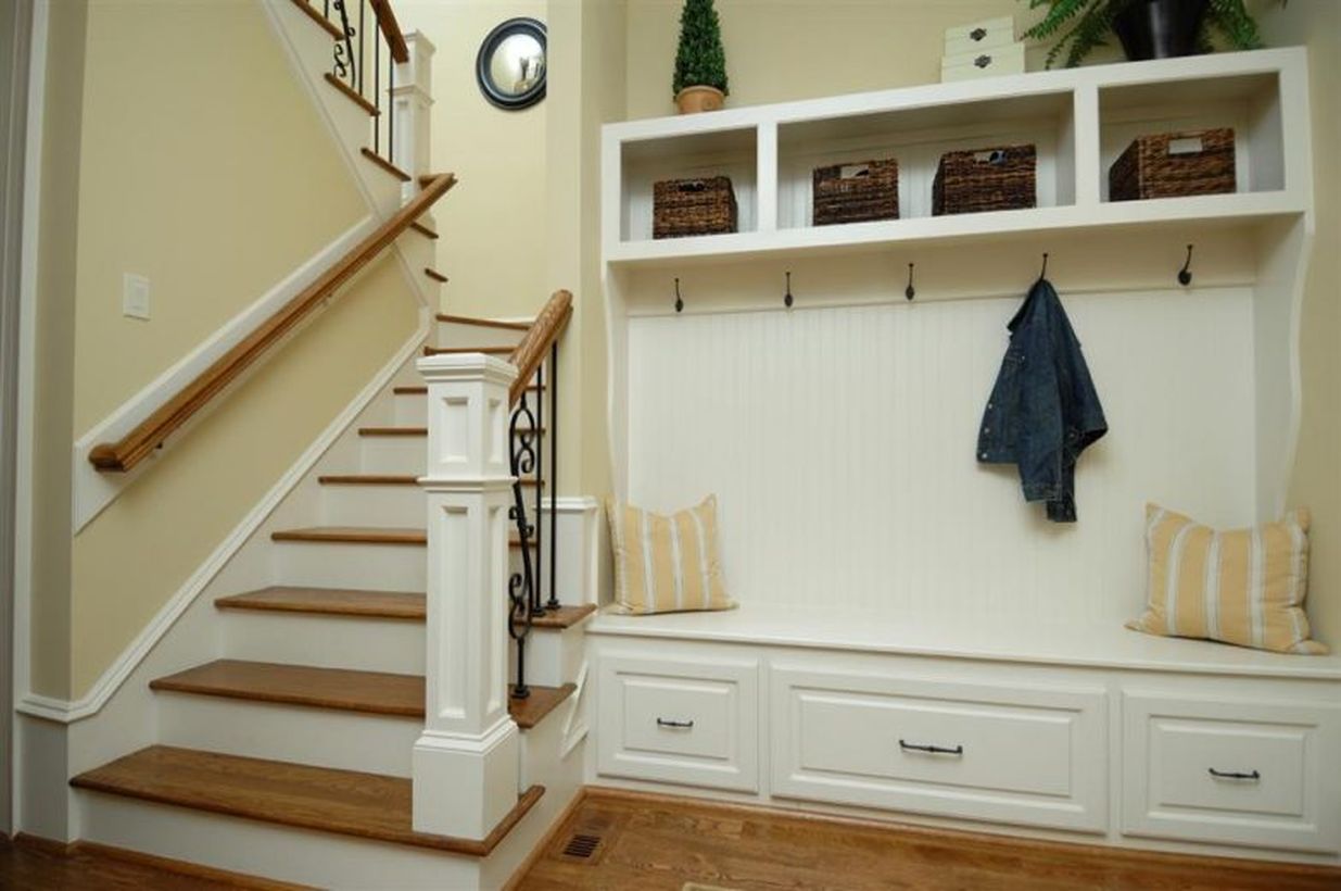 White-wood-entryway-bench-seat-with-coat-rack-and-clothing-hooks-beside-stairs-with-drawer-pillow-and-small-rattan-storage-ideas-783x520