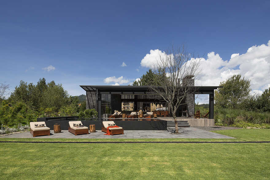 Dark grey house in modern construction of purified lines with rustic touches 1