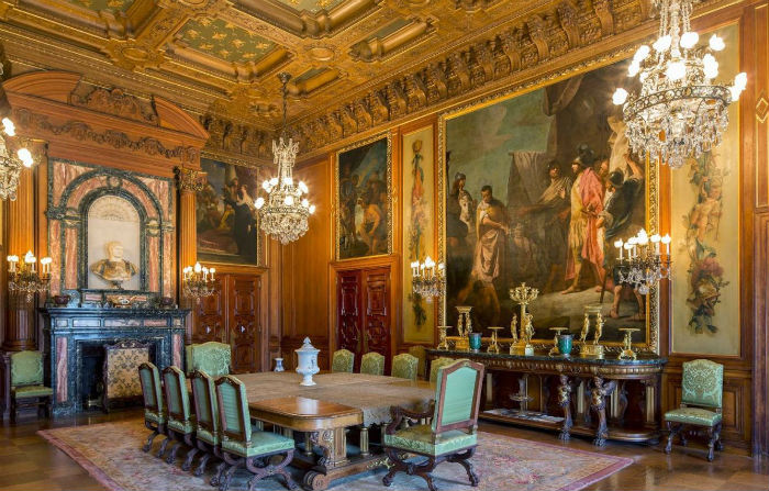 Amazing-dining-room-with-renaissance-interior-design-with-fireplace-and-chandeliers-and-sconces-and-wall-painting-and-large-dining-table-and-console-table-and-chairs