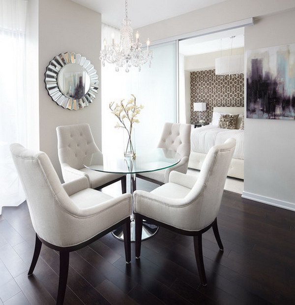 Contemporary-dining-room-with-rounded-glass-table-and-cozy-dining-chairs