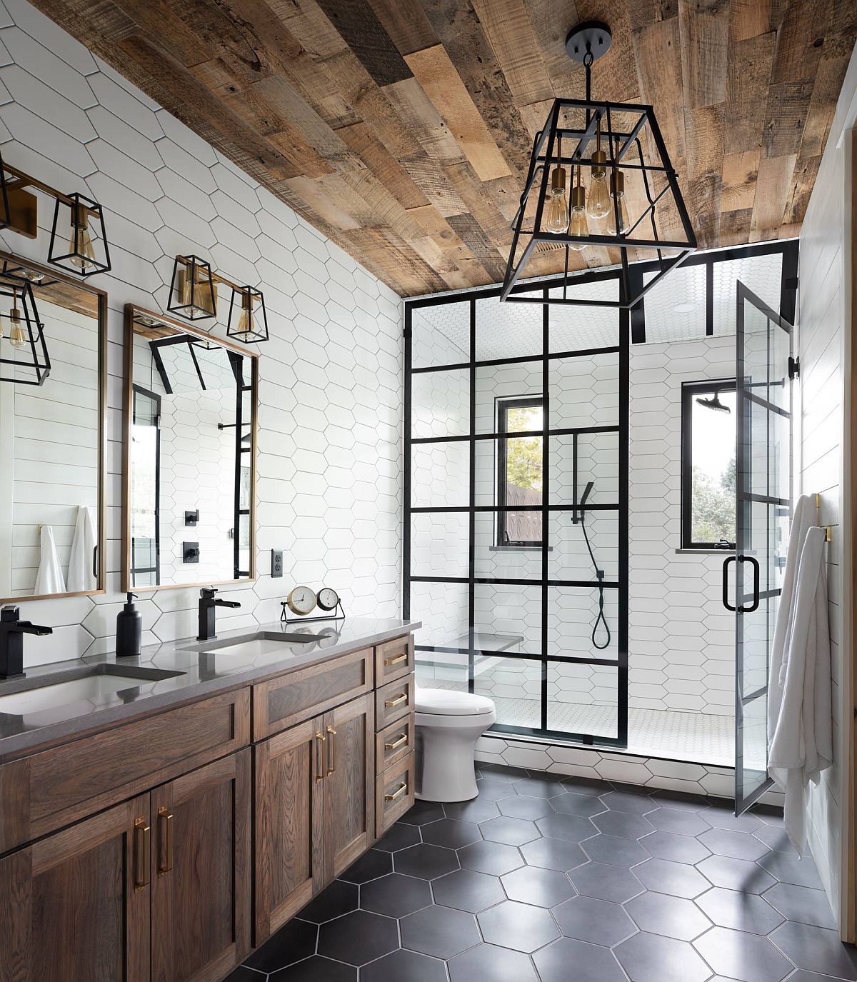 Gorgeous-industrial-farmhouse-style-bathroom-with-hexagonal-gray-floor-tiles.-wooden-ceiling-and-lovely-dark-framed-shower-area-81569