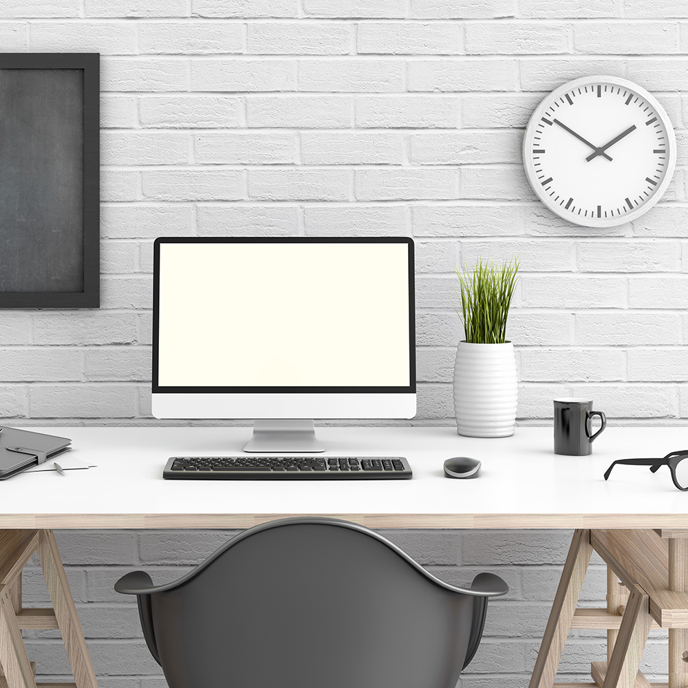 Table with pc in front of a white wall