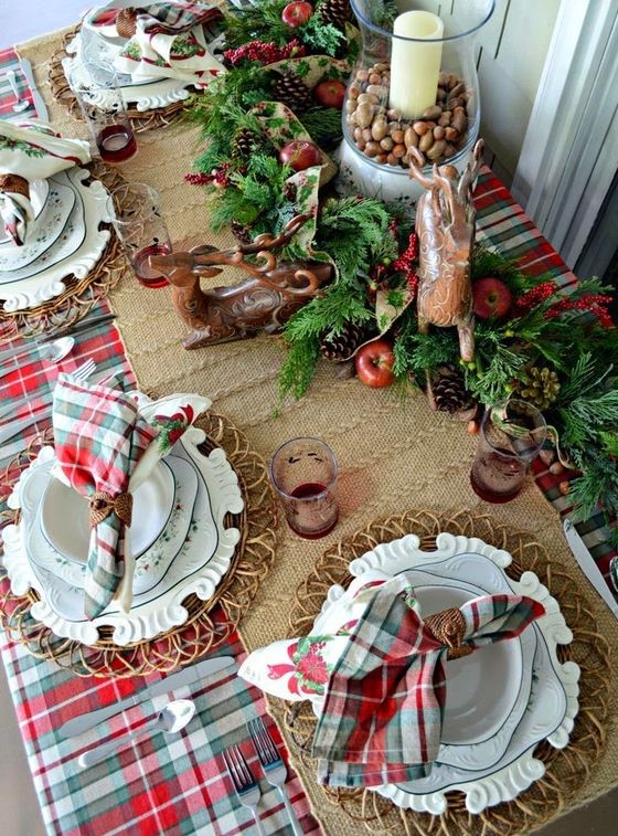 03-a-lush-evergreen-garland-with-pinecones-apples-deer-figurines-and-a-candle-lantern-with-nuts