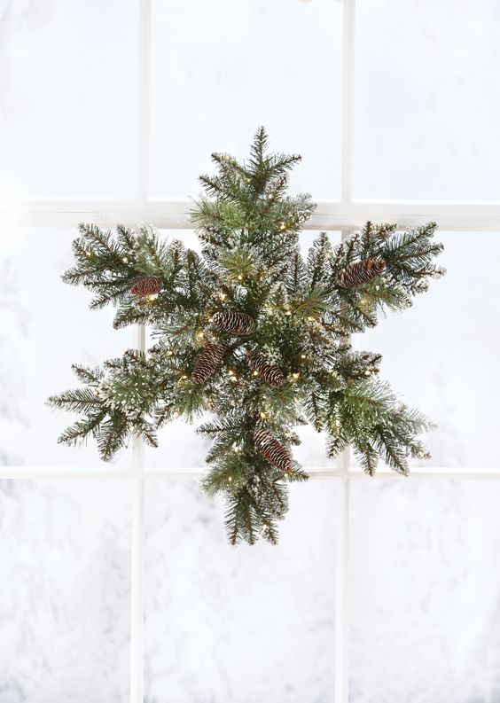 06-a-snowy-evergreen-christmas-wreath-with-pinecones-and-lights-shaped-as-a-snowflake