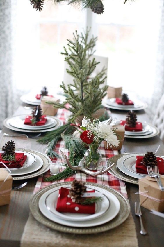 09-a-cozy-rustic-table-setting-with-a-plaid-runner-antlers-evergreens-and-pinecones-for-each-place-setting