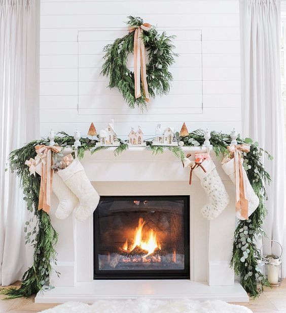 1-03-evergreen-garland-and-wreath-bows-and-small-houses-make-the-fireplace-very-cozy