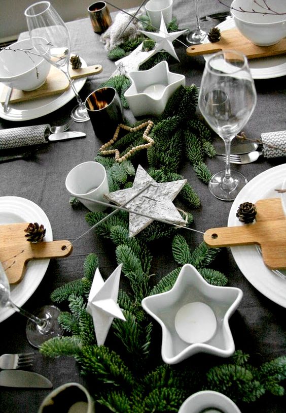 1-25-a-table-setting-with-faux-evergreens-star-shaped-candle-holders-and-pinecones