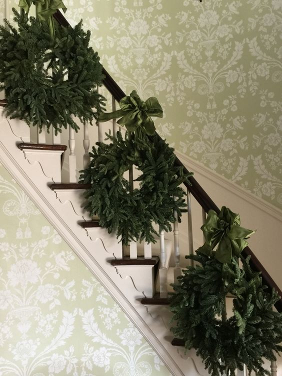 14-a-trio-of-evergreen-wreaths-with-emerald-ribbon-bows-for-decorating-stairs
