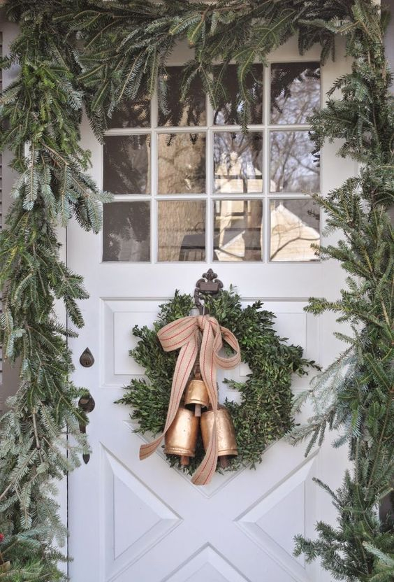 15-a-lush-evergreen-garland-to-frame-the-font-door-and-a-wreath-with-bells-to-match-the-look