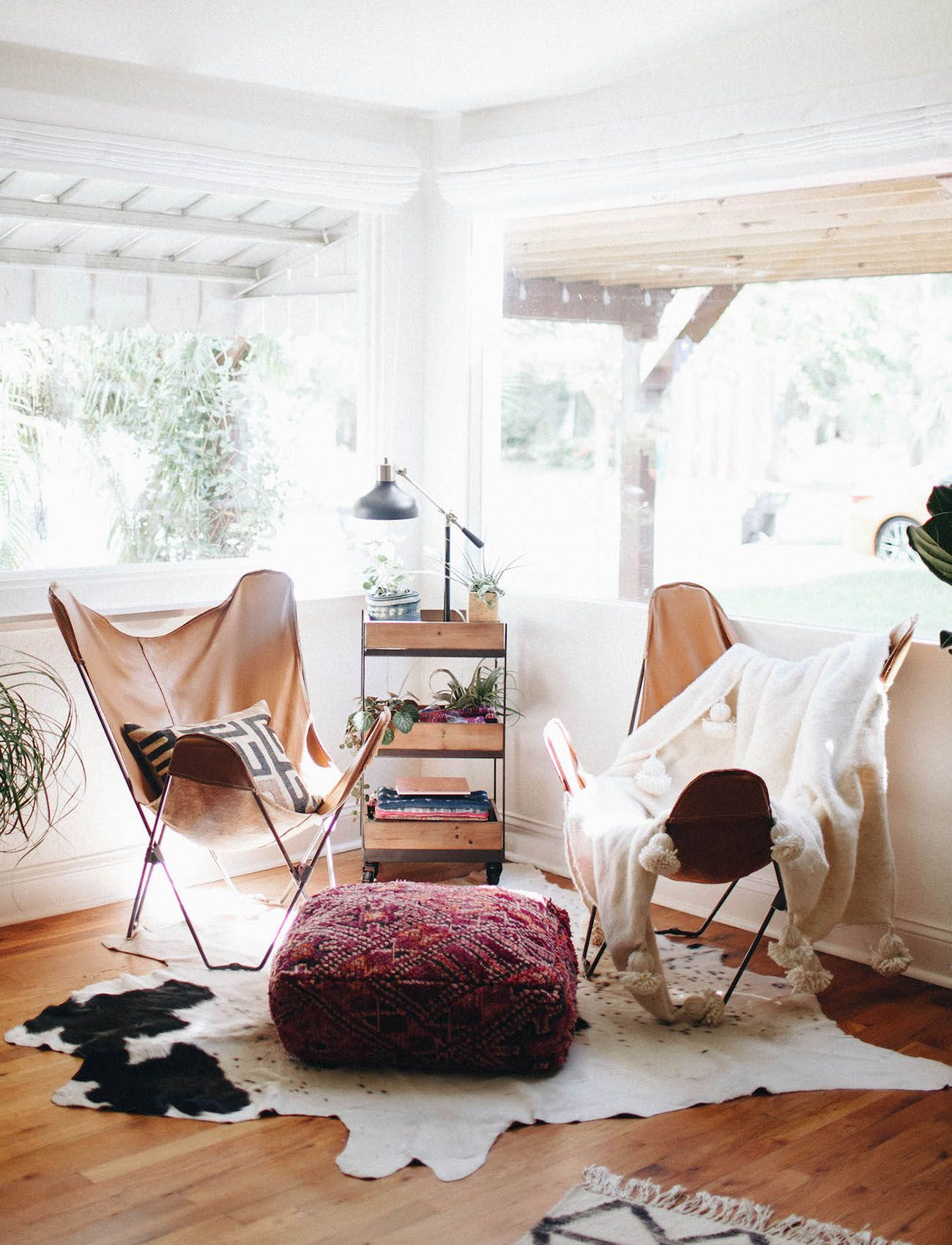 Boho-seating-leather-butterfly-chairs-a-textile-pouf-ottoman-and-fur-throws