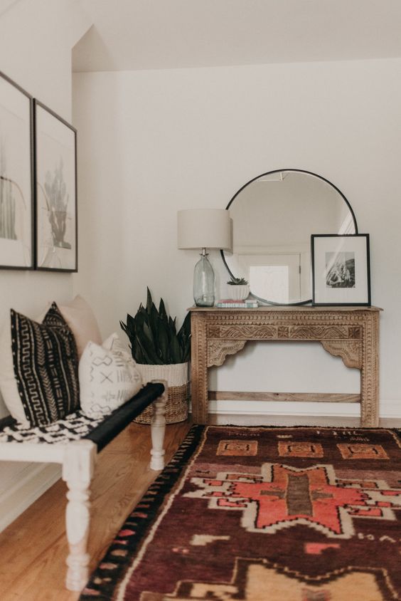 04-a-boho-entryway-with-a-vintage-encrusted-console-a-woven-bench-pillows-artworks-and-succulents