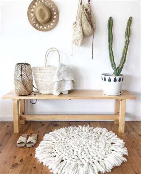 09-a-wooden-bench-a-woven-rug-cacti-in-pots-a-candle-lantern-and-some-hats