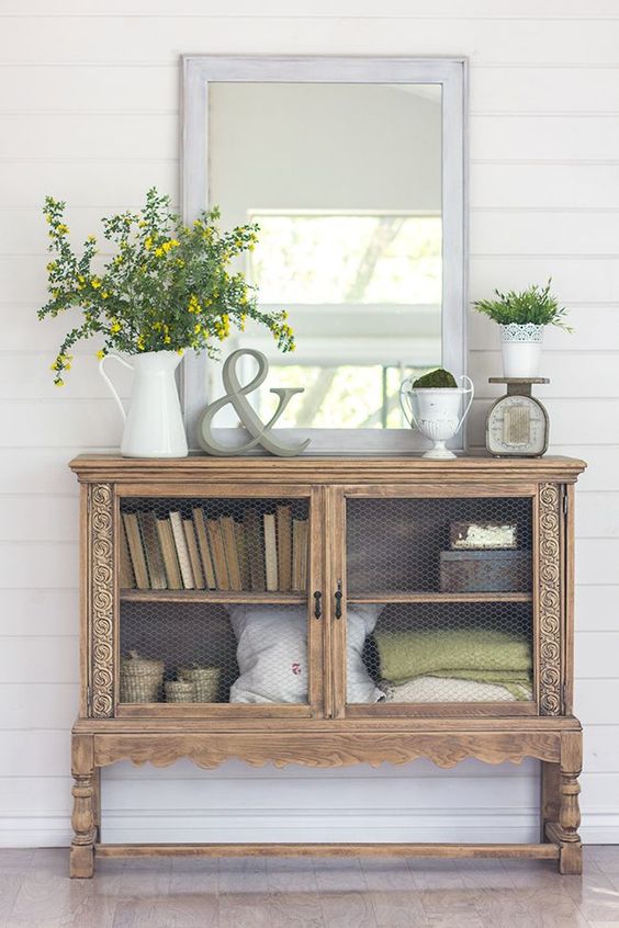1-04-a-vintage-console-with-some-greenery-in-a-jug-a-pot-and-a-moss-ball