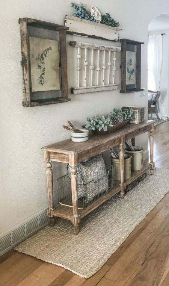 1-a-vintage-meets-farmhouse-entryway-with-a-wooden-console-vintage-posters-as-artworks-and-some-jute-integrated