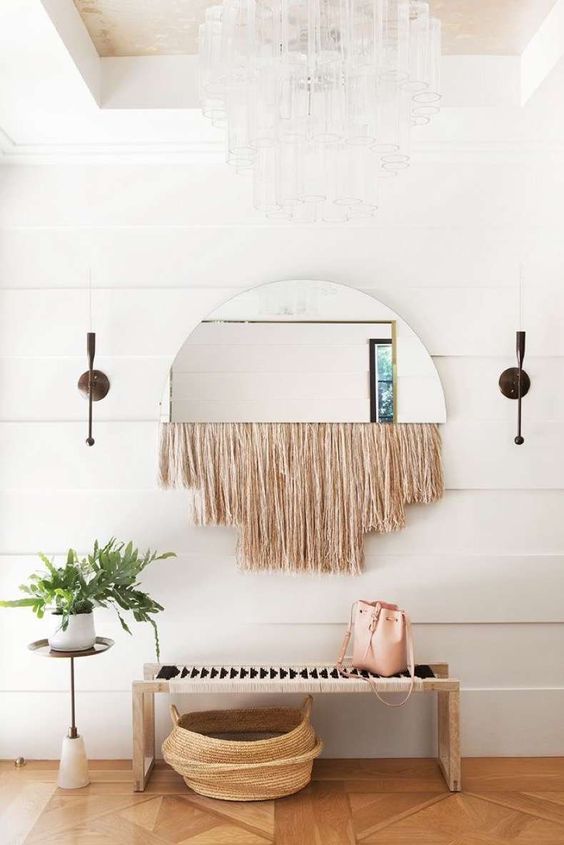 20-a-boho-space-with-a-woven-bench-a-woven-basket-a-mirror-with-fringe-and-a-potted-plant