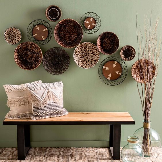23-a-wood-and-metal-bench-woven-and-fringe-pillows-an-arrangement-of-plates-and-some-branches
