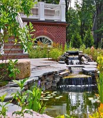 Home entrance accented by pond Innovative Landscape Ideas For Water Features To Create A New Look