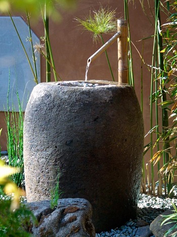 Stone-colored fountain with bamboo water feeder Innovative Landscape Ideas For Water Features To Create A New Look