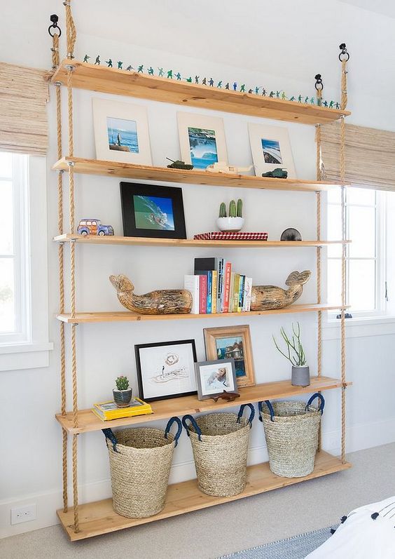 2-24-an-oversized-hanging-shelving-unit-with-ropes-and-shelves-going-down-to-the-floor-and-baskets-on-the-lowest-piece