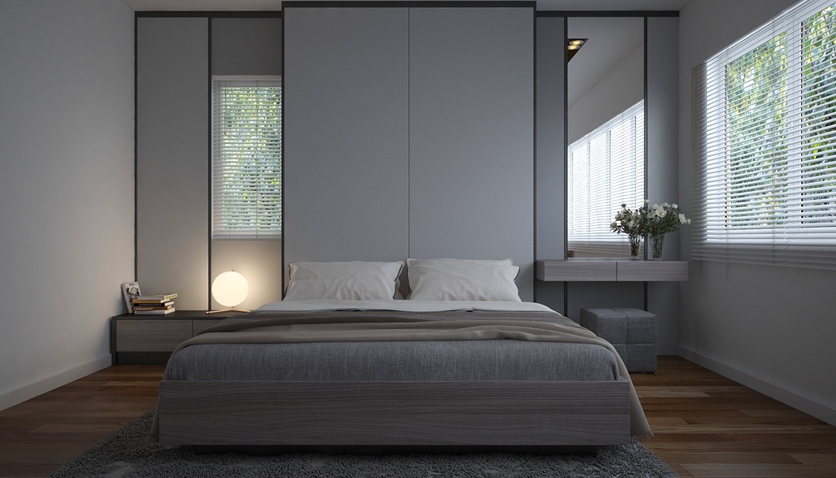Grey-and-white-bedroom-with-mirrors-either-side-on-wooden-floor