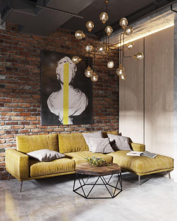 A-brick-wall-a-metal-ceiling-a-concrete-floor-makes-up-a-cool-base-for-an-industrial-living-room-and-a-bulb-chandelier-adds-to-it