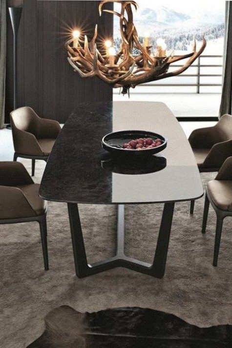 A-modern-chalet-dining-room-with-a-sleek-marble-dining-table-chairs-an-antler-chandelier-and-a-faux-fur-rug-1