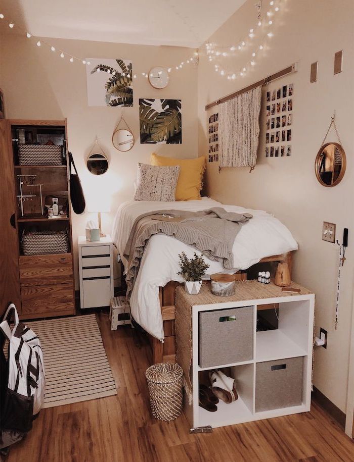 Bed-made-of-palettes-white-walls-with-art-and-polaroids-on-it-teenage-girl-bedroom-ideas-for-small-rooms-fairy-lights-hanging-from-the-ceiling
