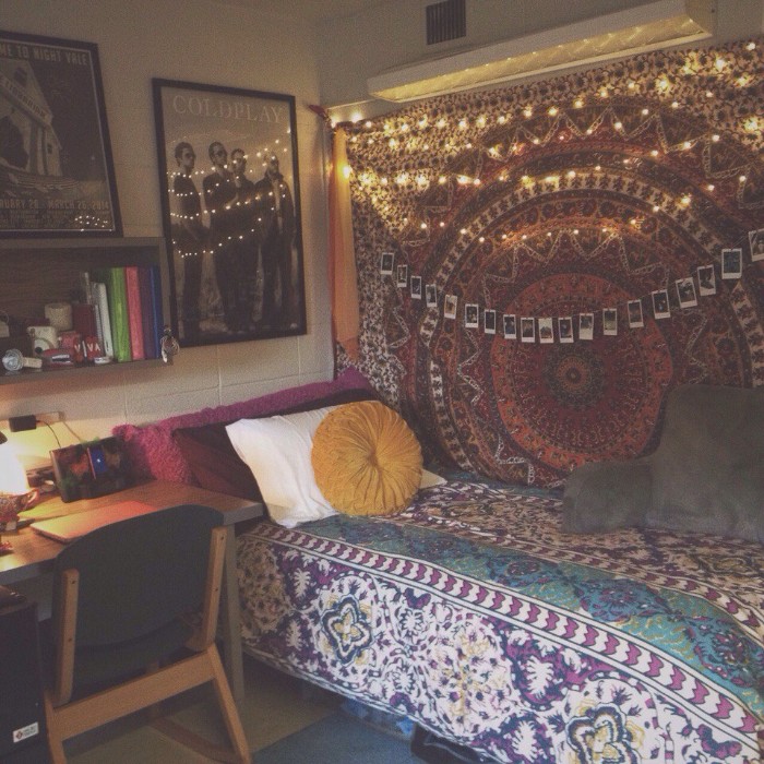 Boho-style-teen-bedrooms-colorful-mandala-fabric-wall-hanging-decorated-with-lit-fairy-lights-and-polaroid-photos-on-a-string-near-a-single-bed-with-multicolored-patterned-bed-covers